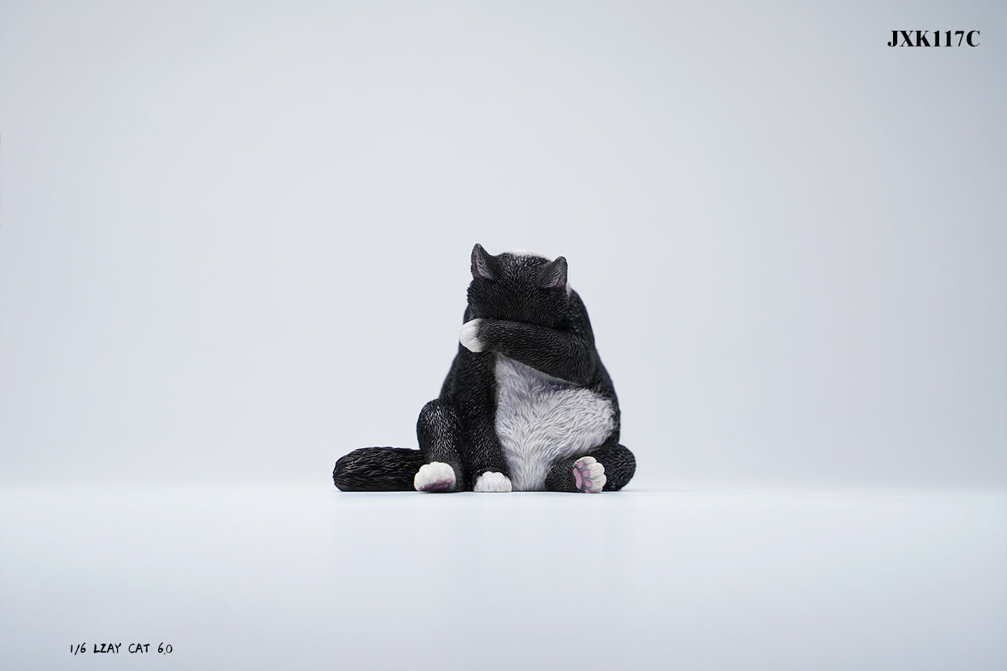 A 1/6 scale model of a lazy cat in various poses, including a ginger cat lounging on a blue bean bag. This highly detailed figurine captures the whimsical and relaxed nature of the cat, making it a perfect collectible for cat lovers and miniature enthusiasts.