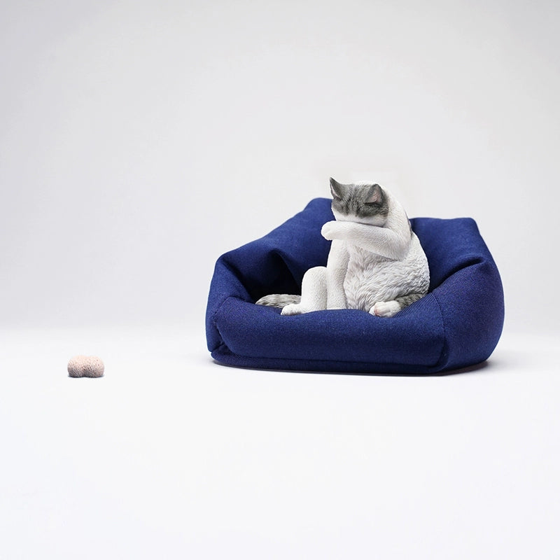  Image Rename: lazy-cat-6-model.jpg  Alt Text: A 1/6 scale model of a lazy cat in various poses, including a ginger cat lounging on a blue bean bag. This highly detailed figurine captures the whimsical and relaxed nature of the cat, making it a perfect collectible for cat lovers and miniature enthusiasts.