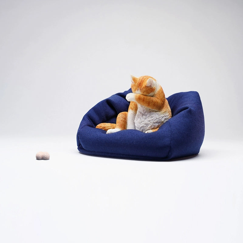  Image Rename: lazy-cat-6-model.jpg  Alt Text: A 1/6 scale model of a lazy cat in various poses, including a ginger cat lounging on a blue bean bag. This highly detailed figurine captures the whimsical and relaxed nature of the cat, making it a perfect collectible for cat lovers and miniature enthusiasts.