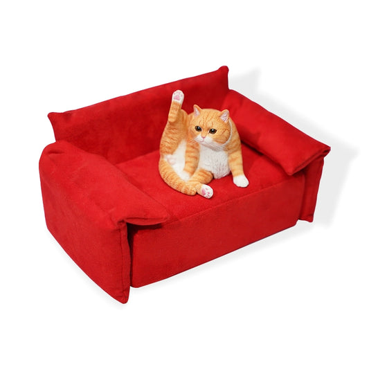 A group of four 1/6 scale lazy cat models, each in different colors and poses, sitting and stretching on a vibrant red sofa. The detailed resin models depict cats in various relaxed postures, showcasing intricate textures and lifelike features.