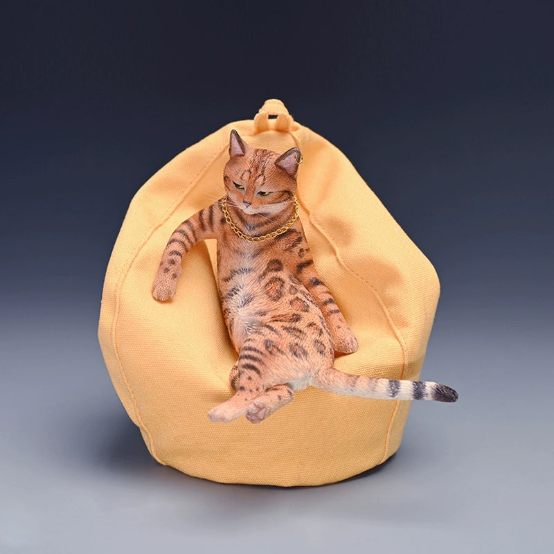 A 1/6 scale leopard cat model lounging on a yellow beanbag. The figurine captures the relaxed and lifelike features of a leopard cat wearing a gold chain, making it a charming decorative piece.