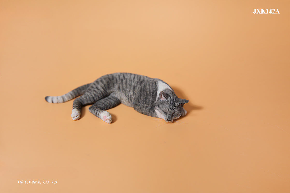 A realistic 1/6 scale model of a relaxed gray cat sleeping on a soft, gray couch, accompanied by two other cat figures lying nearby. The cat figures are detailed with life-like features, capturing their lazy and content postures, perfect for collectors and cat enthusiasts.