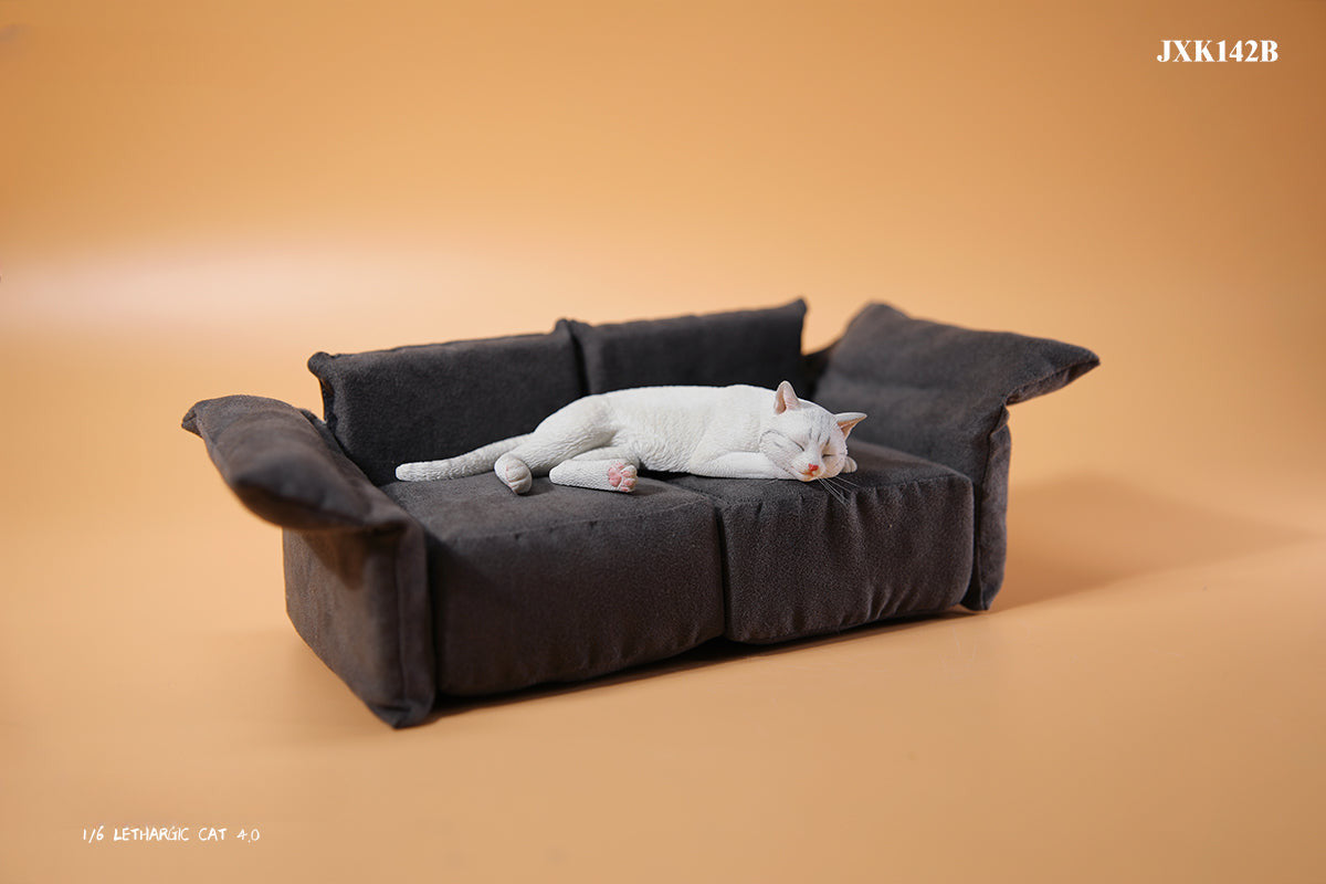 A realistic 1/6 scale model of a relaxed gray cat sleeping on a soft, gray couch, accompanied by two other cat figures lying nearby. The cat figures are detailed with life-like features, capturing their lazy and content postures, perfect for collectors and cat enthusiasts.