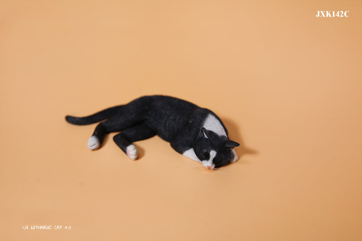 A realistic 1/6 scale model of a relaxed gray cat sleeping on a soft, gray couch, accompanied by two other cat figures lying nearby. The cat figures are detailed with life-like features, capturing their lazy and content postures, perfect for collectors and cat enthusiasts.