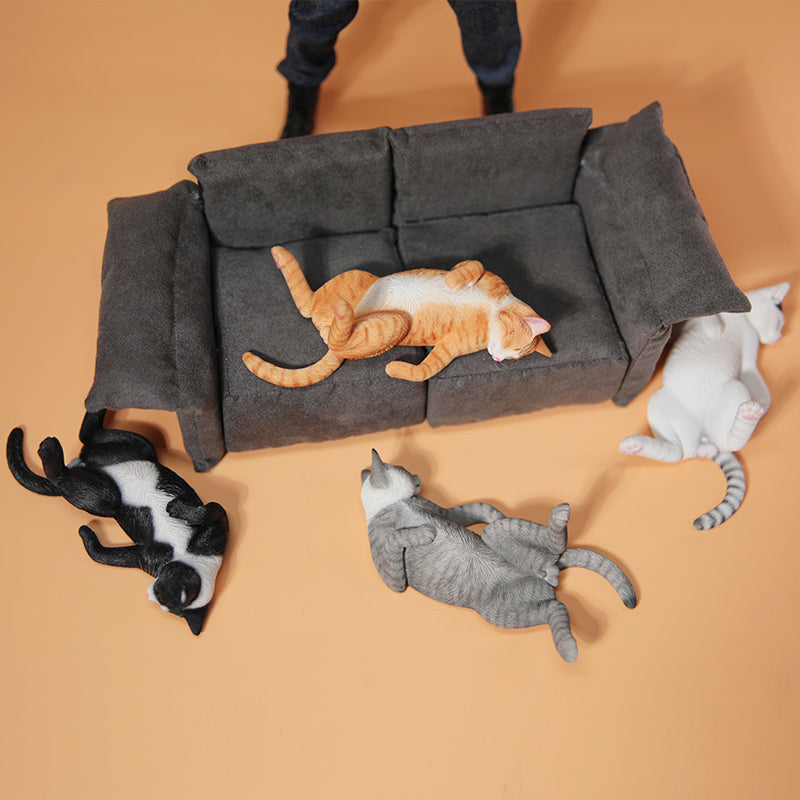 A set of 1/6 scale Lethargic Cat 5.0 models showing various cats in different relaxed, sleeping positions. Each cat is detailed with realistic fur textures and unique coat colors, resting on a grey cushion or a dark grey couch, perfectly capturing the essence of a lazy cat's nap.