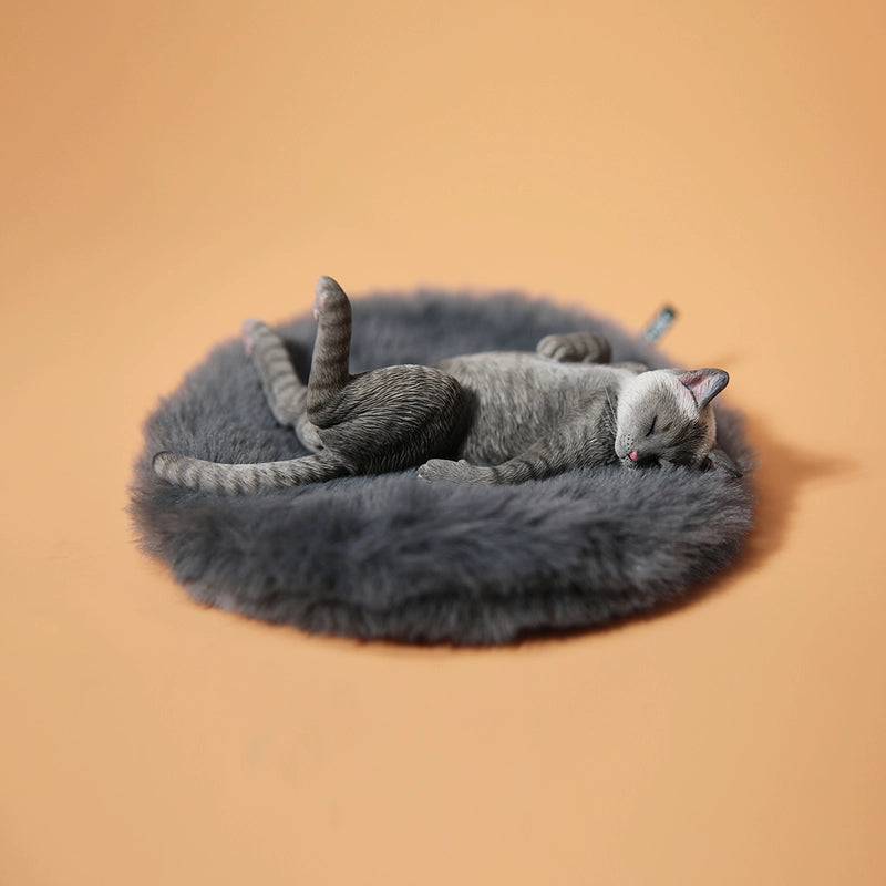 A set of 1/6 scale Lethargic Cat 5.0 models showing various cats in different relaxed, sleeping positions. Each cat is detailed with realistic fur textures and unique coat colors, resting on a grey cushion or a dark grey couch, perfectly capturing the essence of a lazy cat's nap.