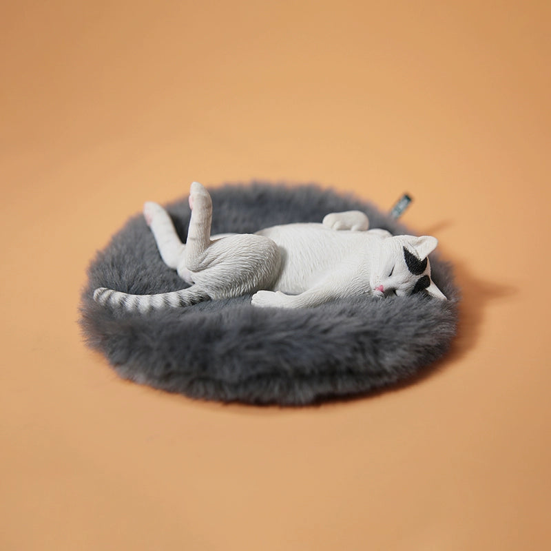 A set of 1/6 scale Lethargic Cat 5.0 models showing various cats in different relaxed, sleeping positions. Each cat is detailed with realistic fur textures and unique coat colors, resting on a grey cushion or a dark grey couch, perfectly capturing the essence of a lazy cat's nap.