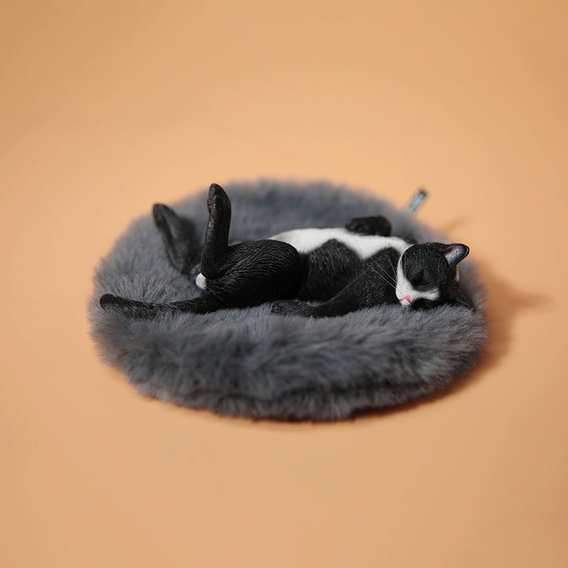 A set of 1/6 scale Lethargic Cat 5.0 models showing various cats in different relaxed, sleeping positions. Each cat is detailed with realistic fur textures and unique coat colors, resting on a grey cushion or a dark grey couch, perfectly capturing the essence of a lazy cat's nap.