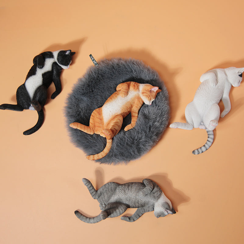 A set of 1/6 scale Lethargic Cat 5.0 models showing various cats in different relaxed, sleeping positions. Each cat is detailed with realistic fur textures and unique coat colors, resting on a grey cushion or a dark grey couch, perfectly capturing the essence of a lazy cat's nap.