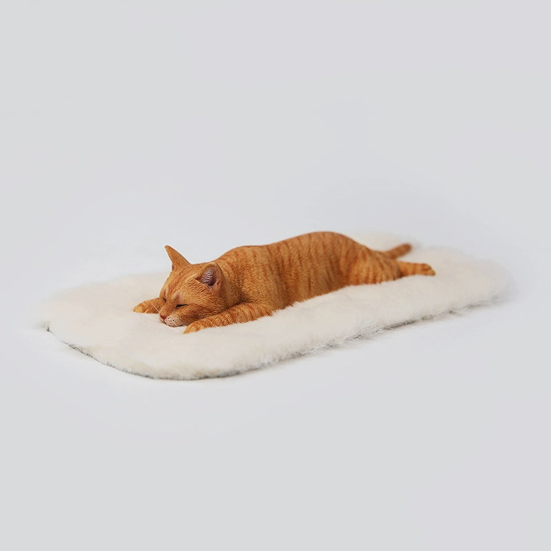 A detailed 1/6 scale resin model of a lephargic cat lying flat on its stomach. The cat, with realistic fur texture and relaxed pose, rests on a soft white pad. The model captures the essence of a sleepy, content cat.