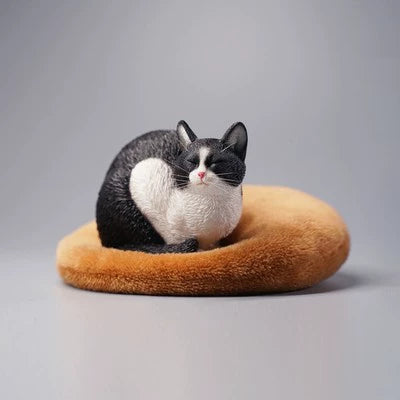 A group of four realistic 1/6 scale models of cats in various resting poses. Each cat model, including a white, black, grey, and orange cat, is crafted with intricate details, capturing the serene and lifelike appearance of a lethargic cat.