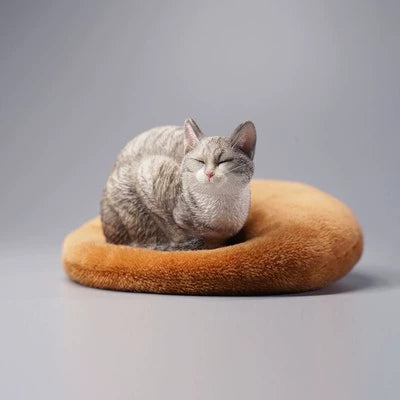 A group of four realistic 1/6 scale models of cats in various resting poses. Each cat model, including a white, black, grey, and orange cat, is crafted with intricate details, capturing the serene and lifelike appearance of a lethargic cat.