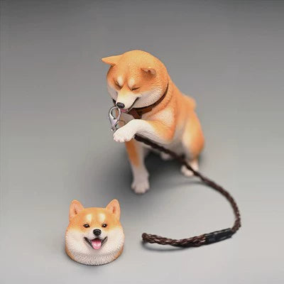 A set of six 1/6 scale Shiba Inu figurines, each striking a cute, playful pose. The dogs are seated with one paw raised, exuding a charming and friendly demeanor. They come in various coat colors, including white, black, and tan, and are depicted with lifelike detailing and cheerful expressions.