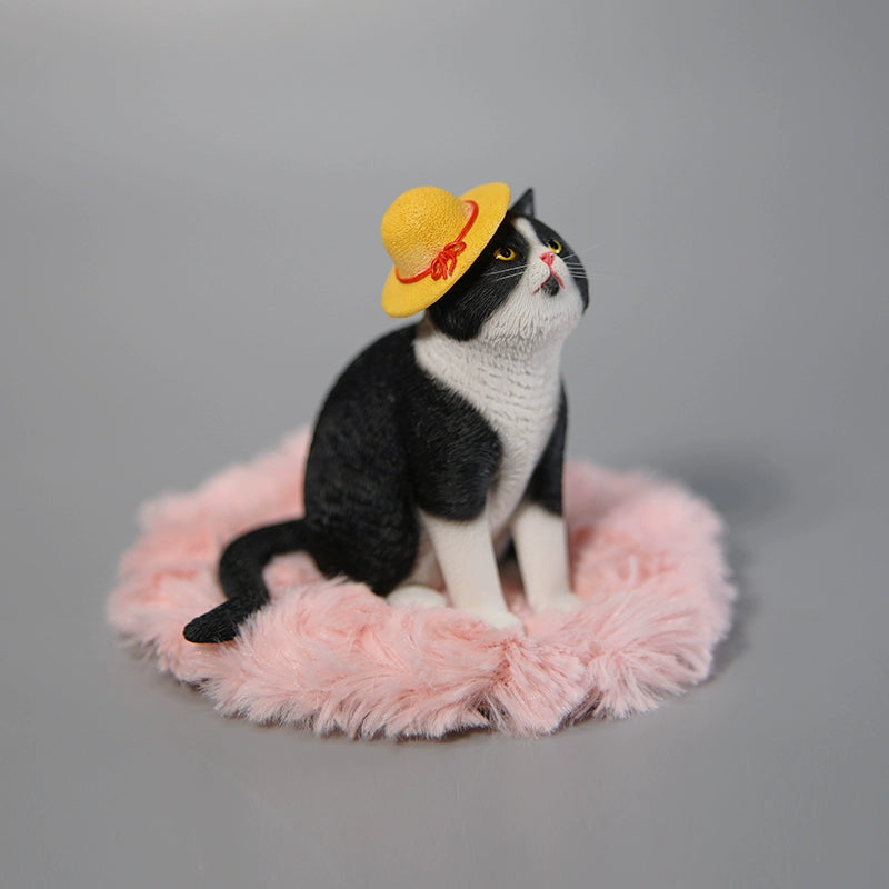 A collection of 1/6 scale Princess Cat Models featuring four distinct cat figurines. Each cat has a unique color and expression, with one cat wearing a yellow hat, sitting on a pink cushion, while others are arranged around a grey couch. The detailed design captures the cats' regal poses, making them a charming addition to any collection.