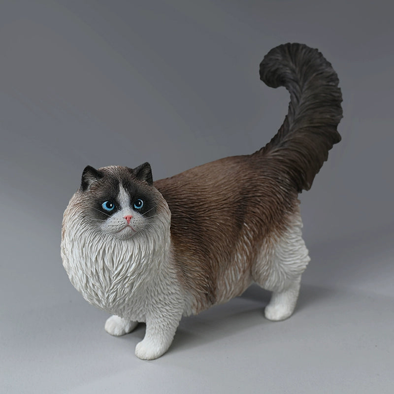 A group of four beautifully crafted Ragdoll cat resin models in various realistic poses and coat colors. The models are shown interacting with a person, highlighting their lifelike details and expressive faces.