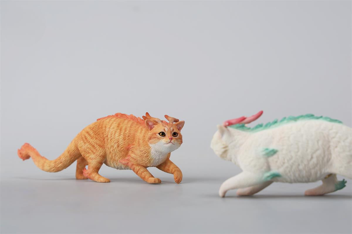 A highly detailed Catragon Figurine featuring a white feline with dragon-like features, including pastel green fur accents and delicate horns. This resin-crafted fantasy cat-dragon hybrid is an artistic and whimsical collectible. Ideal for display or as a gift for cat lovers and fantasy enthusiasts.