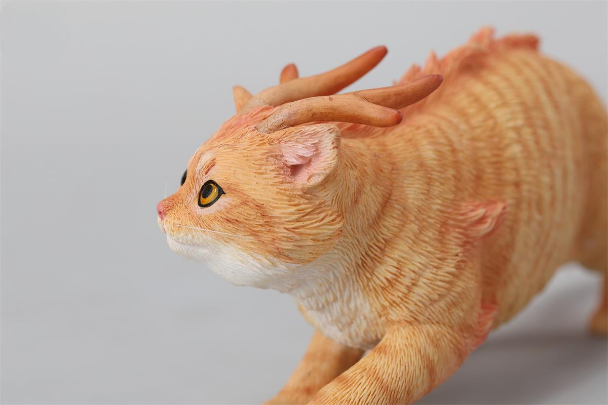 A highly detailed Catragon Figurine featuring a white feline with dragon-like features, including pastel green fur accents and delicate horns. This resin-crafted fantasy cat-dragon hybrid is an artistic and whimsical collectible. Ideal for display or as a gift for cat lovers and fantasy enthusiasts.