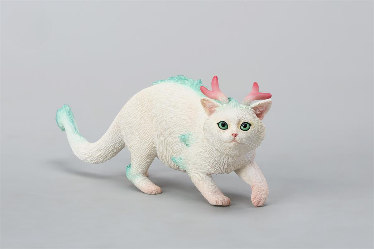 A highly detailed Catragon Figurine featuring a white feline with dragon-like features, including pastel green fur accents and delicate horns. This resin-crafted fantasy cat-dragon hybrid is an artistic and whimsical collectible. Ideal for display or as a gift for cat lovers and fantasy enthusiasts.