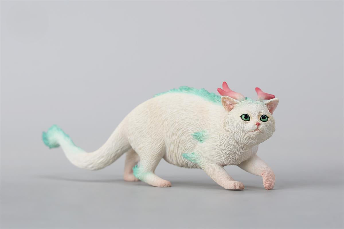 A highly detailed Catragon Figurine featuring a white feline with dragon-like features, including pastel green fur accents and delicate horns. This resin-crafted fantasy cat-dragon hybrid is an artistic and whimsical collectible. Ideal for display or as a gift for cat lovers and fantasy enthusiasts.