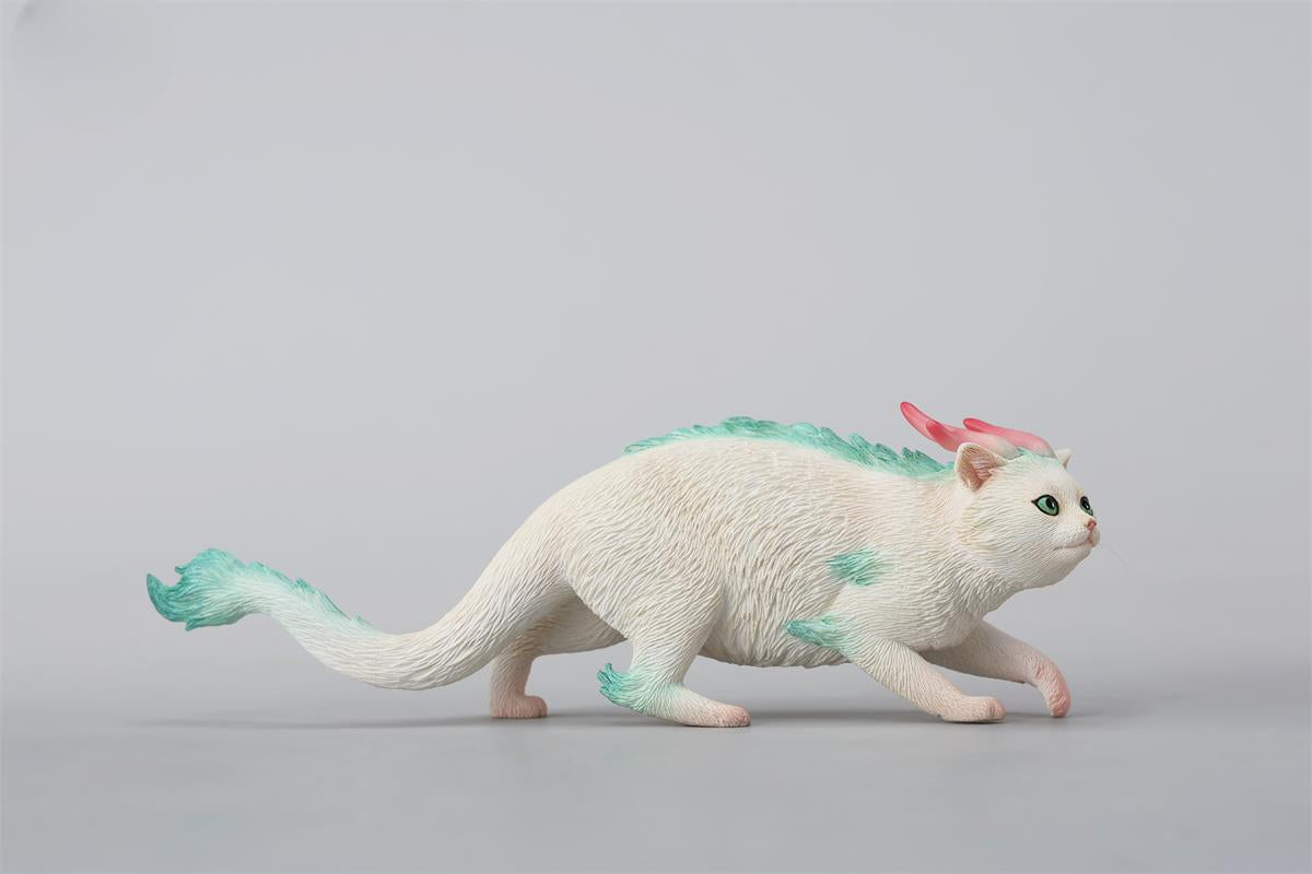 A highly detailed Catragon Figurine featuring a white feline with dragon-like features, including pastel green fur accents and delicate horns. This resin-crafted fantasy cat-dragon hybrid is an artistic and whimsical collectible. Ideal for display or as a gift for cat lovers and fantasy enthusiasts.