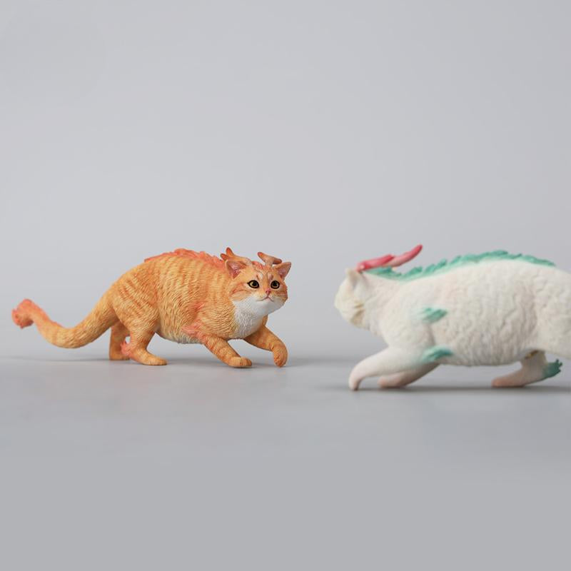 A highly detailed Catragon Figurine featuring a white feline with dragon-like features, including pastel green fur accents and delicate horns. This resin-crafted fantasy cat-dragon hybrid is an artistic and whimsical collectible. Ideal for display or as a gift for cat lovers and fantasy enthusiasts.