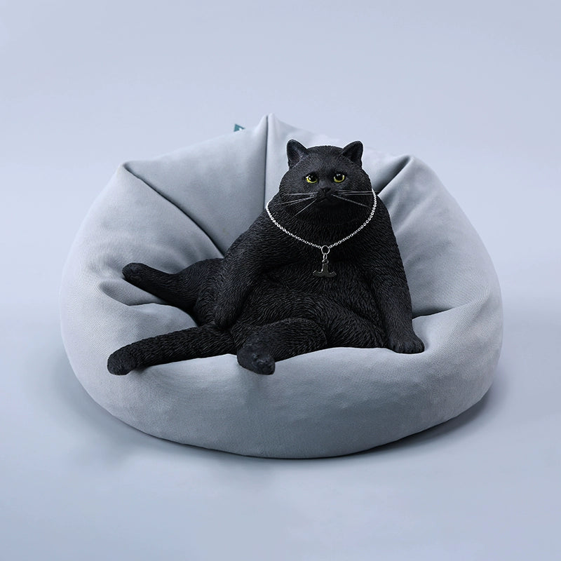 A detailed 1/6 scale model of a plump cat, available in various colors. The cat is depicted in a relaxed, seated position, showcasing lifelike fur textures and an adorable expression. This collectible figurine captures the essence of a lazy, content cat perfectly, making it a charming addition to any collection or home decor.