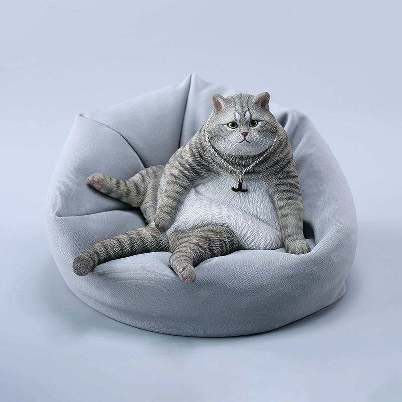 A detailed 1/6 scale model of a plump cat, available in various colors. The cat is depicted in a relaxed, seated position, showcasing lifelike fur textures and an adorable expression. This collectible figurine captures the essence of a lazy, content cat perfectly, making it a charming addition to any collection or home decor.