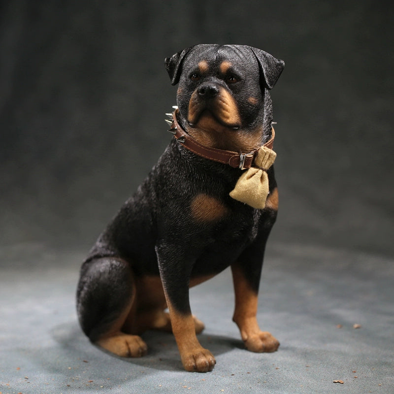 Three intricately detailed Rottweiler dog figurines stand on a grey surface. The figures exhibit lifelike features, from their distinct fur textures to the expressive faces. One wears a spiked collar with a small beige pouch, adding a touch of personality. The lighting emphasizes their muscular build and attentive expressions, making these resin models a perfect representation of the strong and loyal breed.