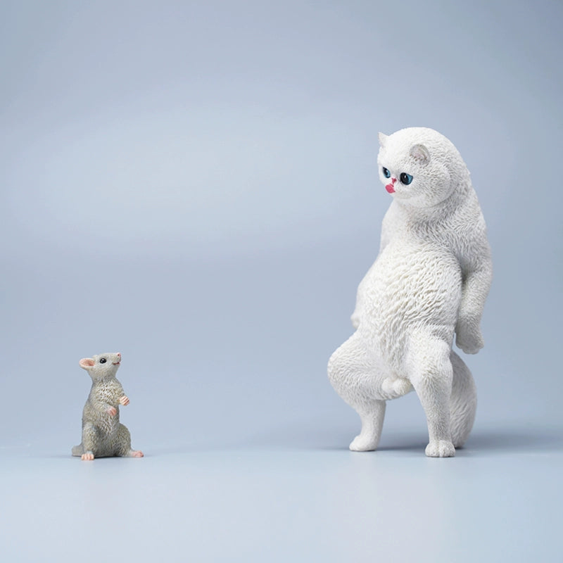 A set of six playful cat figurines featuring a humorous twist with paper bags over their heads. Each figurine showcases a distinct breed and color, from orange to black and white. The cats stand upright with exaggerated expressions, adding a touch of whimsy to any collection.