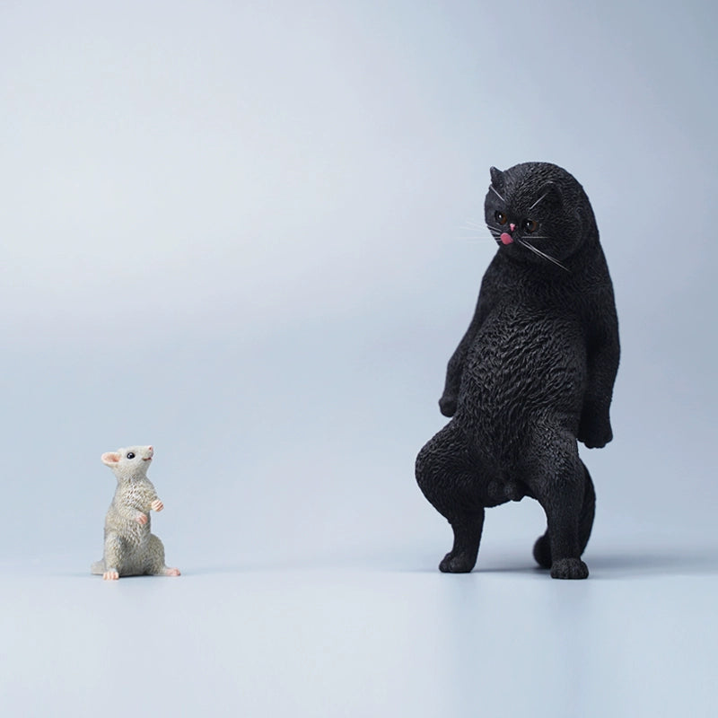 A set of six playful cat figurines featuring a humorous twist with paper bags over their heads. Each figurine showcases a distinct breed and color, from orange to black and white. The cats stand upright with exaggerated expressions, adding a touch of whimsy to any collection.