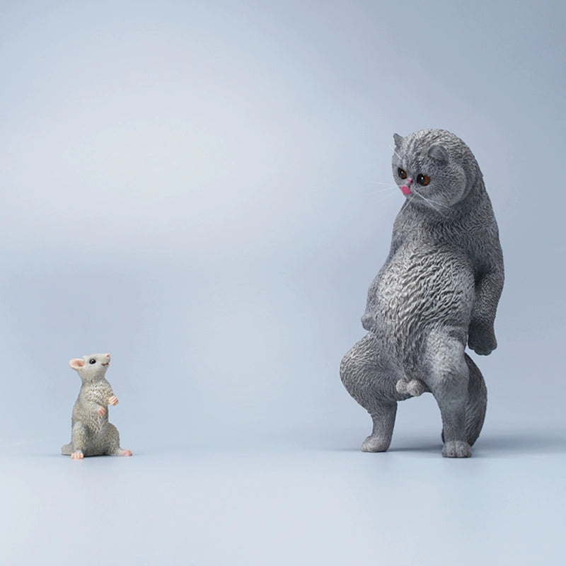 A set of six playful cat figurines featuring a humorous twist with paper bags over their heads. Each figurine showcases a distinct breed and color, from orange to black and white. The cats stand upright with exaggerated expressions, adding a touch of whimsy to any collection.