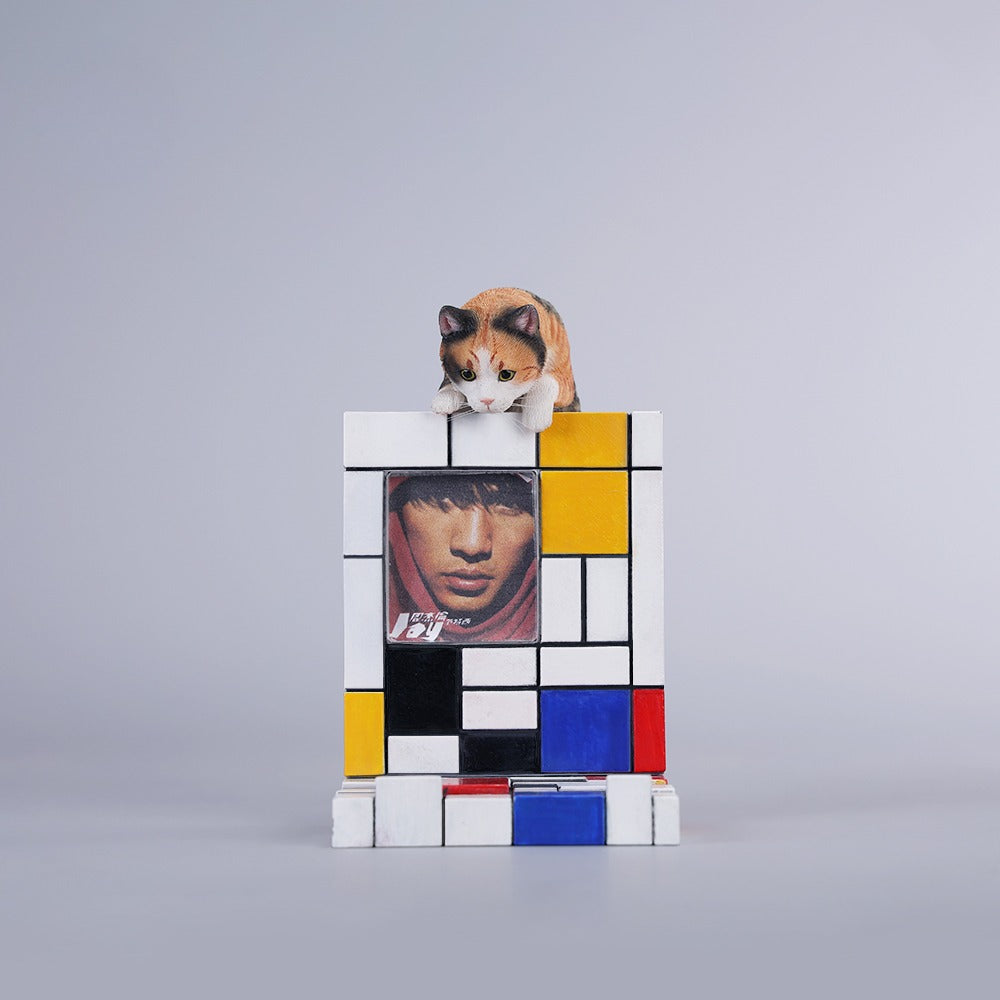 A 1/6 scale Mondrian wall-climbing cat figurine crafted from high-quality resin, featuring a playful cat climbing a colorful cubist-style wall, offering a unique and stylish addition to any home decor.