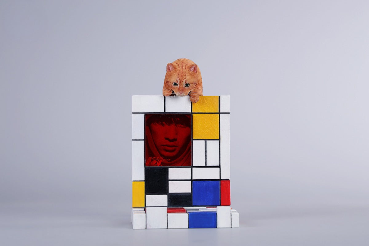 A 1/6 scale Mondrian wall-climbing cat figurine crafted from high-quality resin, featuring a playful cat climbing a colorful cubist-style wall, offering a unique and stylish addition to any home decor.