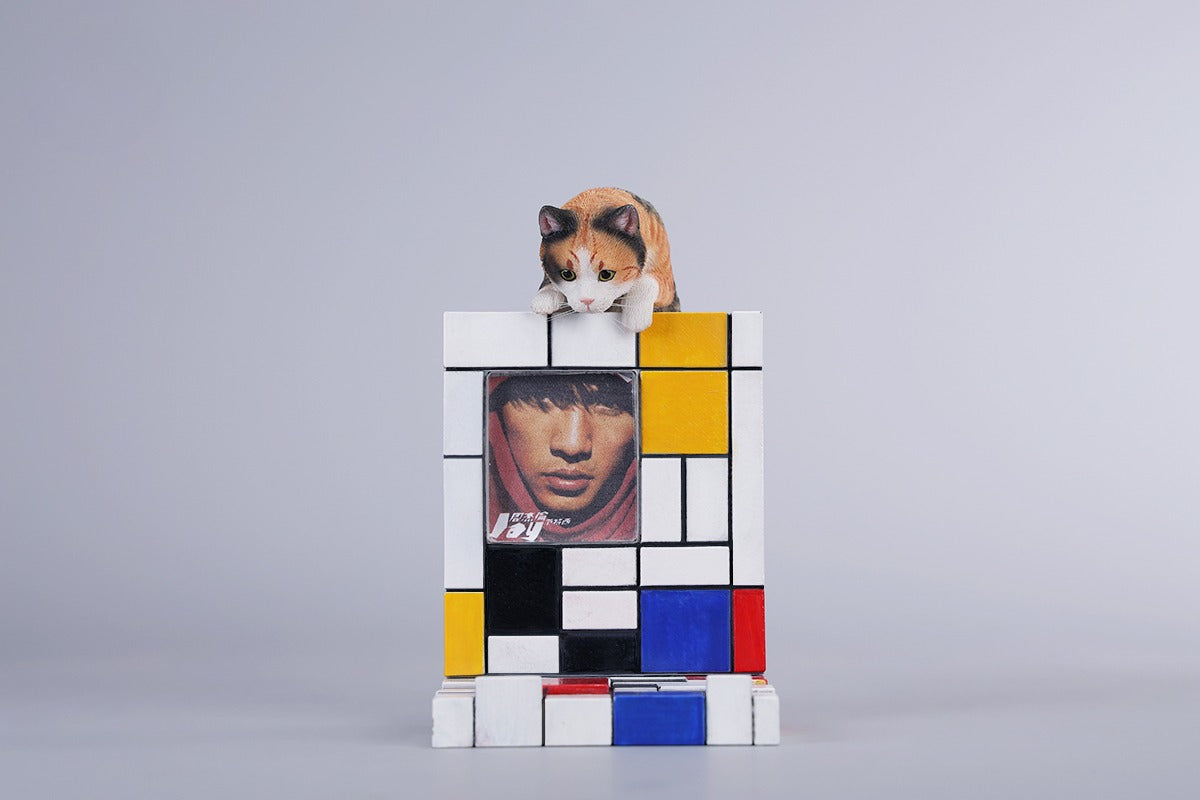 A 1/6 scale Mondrian wall-climbing cat figurine crafted from high-quality resin, featuring a playful cat climbing a colorful cubist-style wall, offering a unique and stylish addition to any home decor.