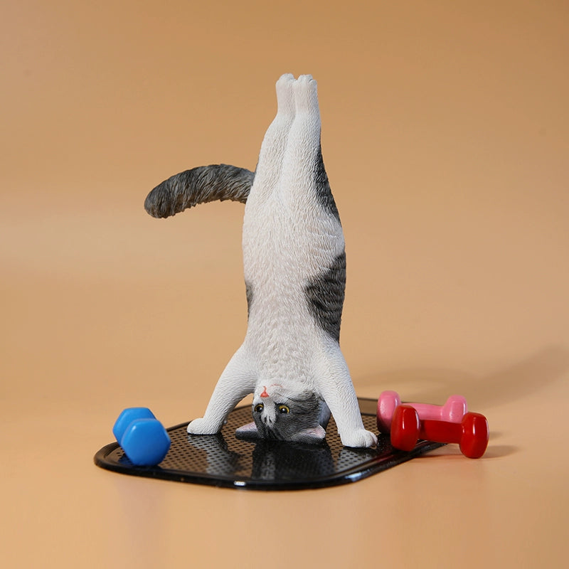 1/6 scale Yoga Cat figurines, each posed in a headstand position, showcasing various fur patterns and colors. These charming and whimsical models capture cats in a playful yoga pose, perfect for collectors and cat lovers. The figurines add a touch of fun and creativity to any display, featuring detailed craftsmanship and lifelike fur textures.