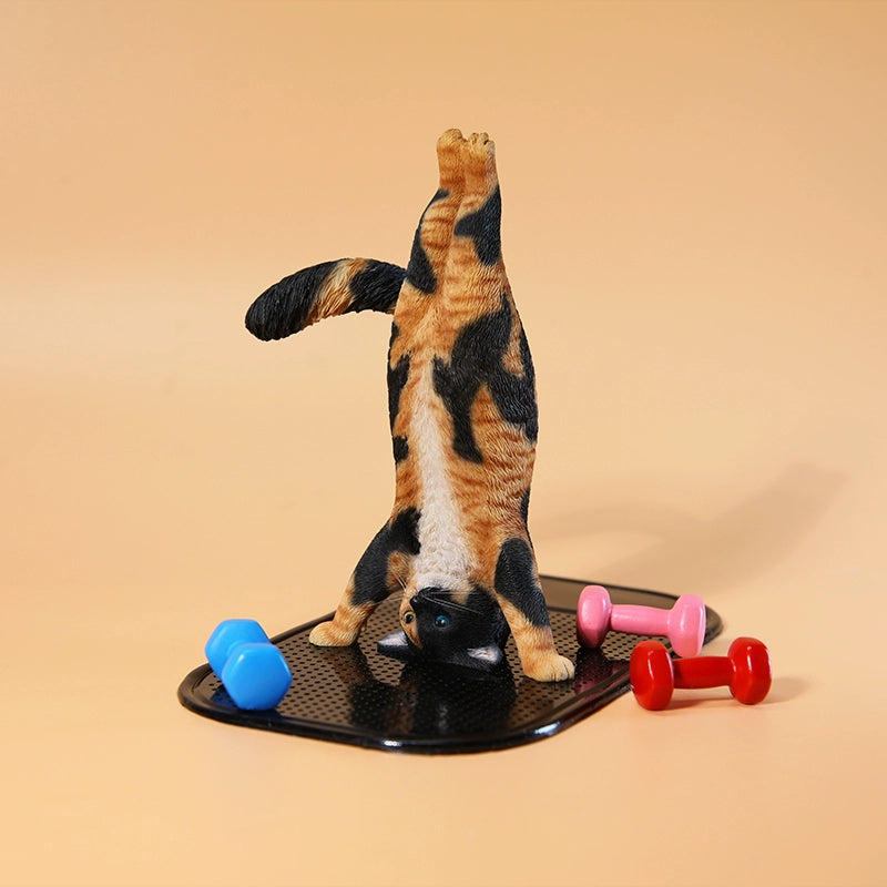 1/6 scale Yoga Cat figurines, each posed in a headstand position, showcasing various fur patterns and colors. These charming and whimsical models capture cats in a playful yoga pose, perfect for collectors and cat lovers. The figurines add a touch of fun and creativity to any display, featuring detailed craftsmanship and lifelike fur textures.