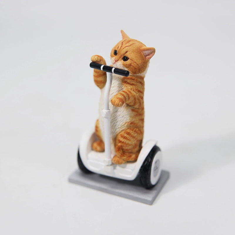 Adorable 1/6 scale Scottish Fold cat figurines, including a black-and-white, white, orange tabby, and grey cat, standing upright. One cat rides a balance car with a playful expression. These resin models showcase the breed's folded ears and expressive eyes, perfect for collectors.