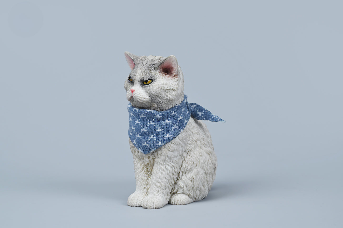 A collection of four 1/6 scale Selkirk Rex 2.0 resin models, each cat adorned with a blue patterned scarf. The cats, featuring different fur colors and expressions, are sitting in a row, capturing the distinctive curly fur and expressive faces characteristic of the Selkirk Rex breed.