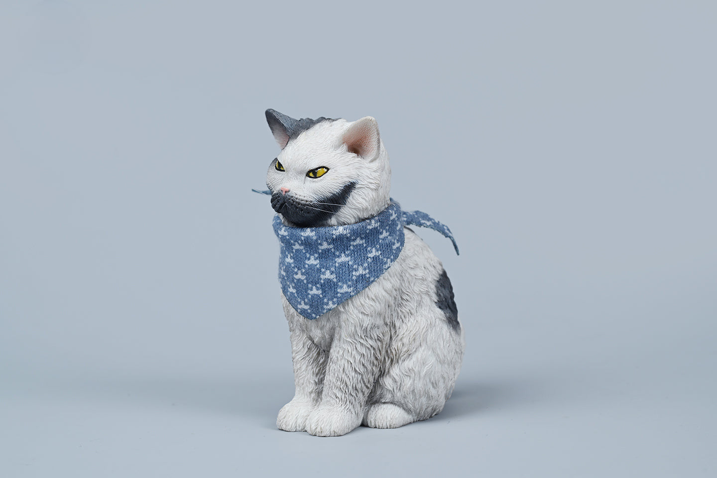 A collection of four 1/6 scale Selkirk Rex 2.0 resin models, each cat adorned with a blue patterned scarf. The cats, featuring different fur colors and expressions, are sitting in a row, capturing the distinctive curly fur and expressive faces characteristic of the Selkirk Rex breed.