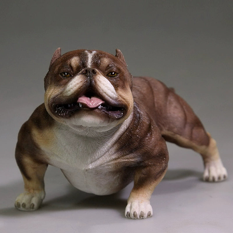 A group of 1/6 scale simulation American Bully dog models posed with a person. The figurines showcase various coat colors and muscular builds, with one close-up highlighting a white bully with a black patch around its eye. These detailed models capture the breed's powerful and robust appearance.