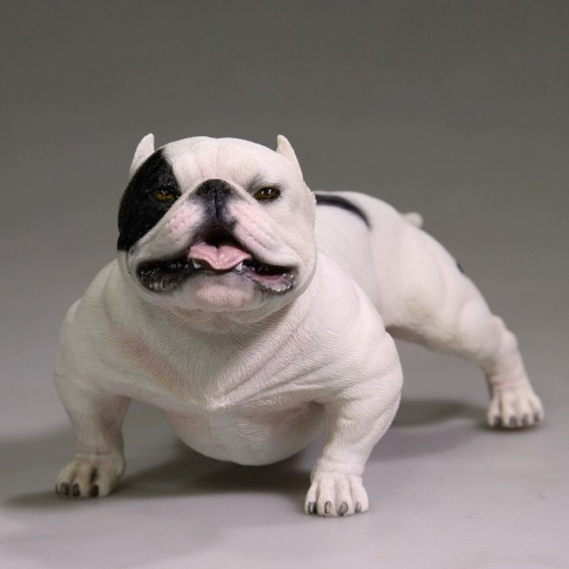 A group of 1/6 scale simulation American Bully dog models posed with a person. The figurines showcase various coat colors and muscular builds, with one close-up highlighting a white bully with a black patch around its eye. These detailed models capture the breed's powerful and robust appearance.