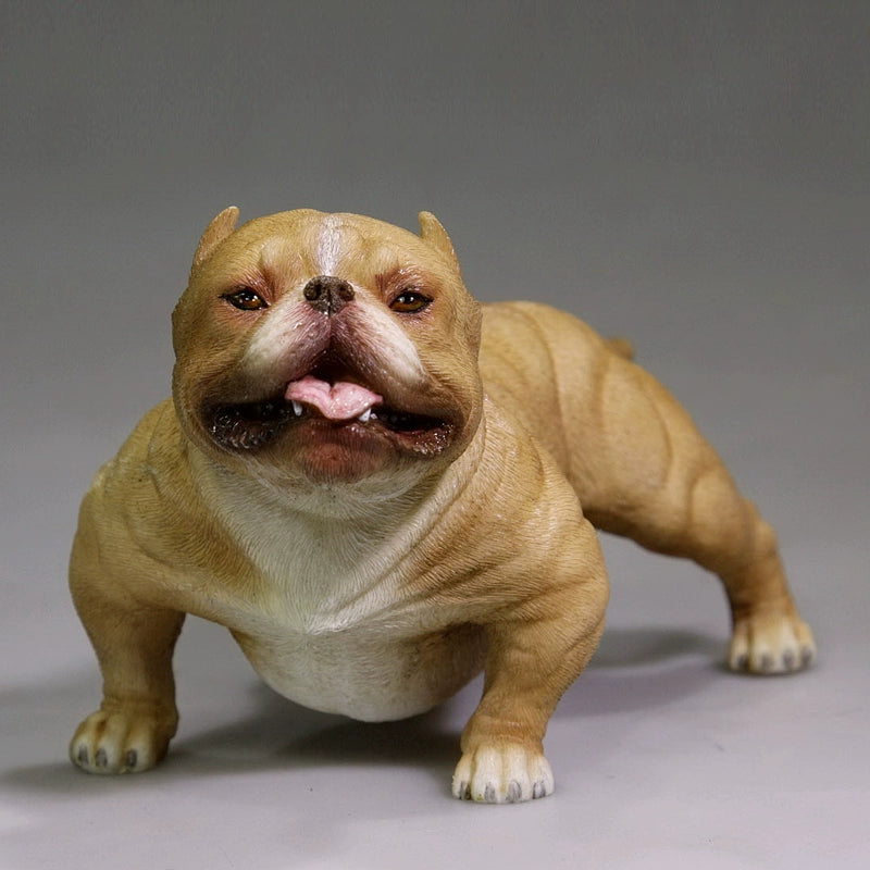 A group of 1/6 scale simulation American Bully dog models posed with a person. The figurines showcase various coat colors and muscular builds, with one close-up highlighting a white bully with a black patch around its eye. These detailed models capture the breed's powerful and robust appearance.