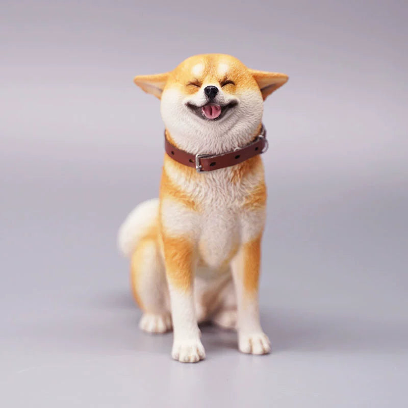 "Three realistic 1/6 scale Shiba Inu dog figurines in a sitting position, showcasing their adorable airplane ear feature. The figurines display three different coat colors: black and tan, red and white, and pure white. Each figurine is intricately detailed with a leather collar, capturing the breed's characteristic cheerful expression."