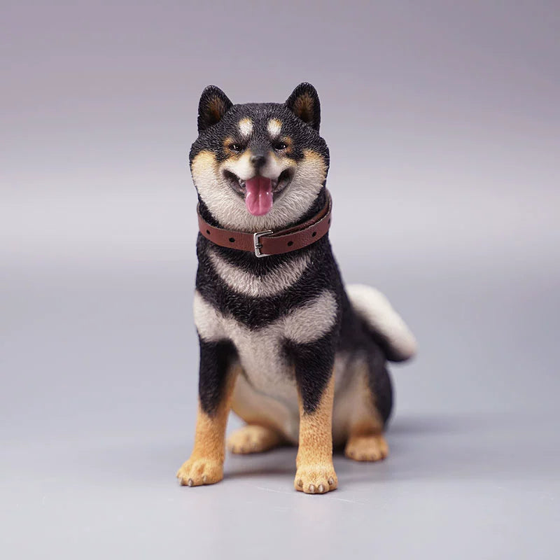"Three realistic 1/6 scale Shiba Inu dog figurines in a sitting position, showcasing their adorable airplane ear feature. The figurines display three different coat colors: black and tan, red and white, and pure white. Each figurine is intricately detailed with a leather collar, capturing the breed's characteristic cheerful expression."
