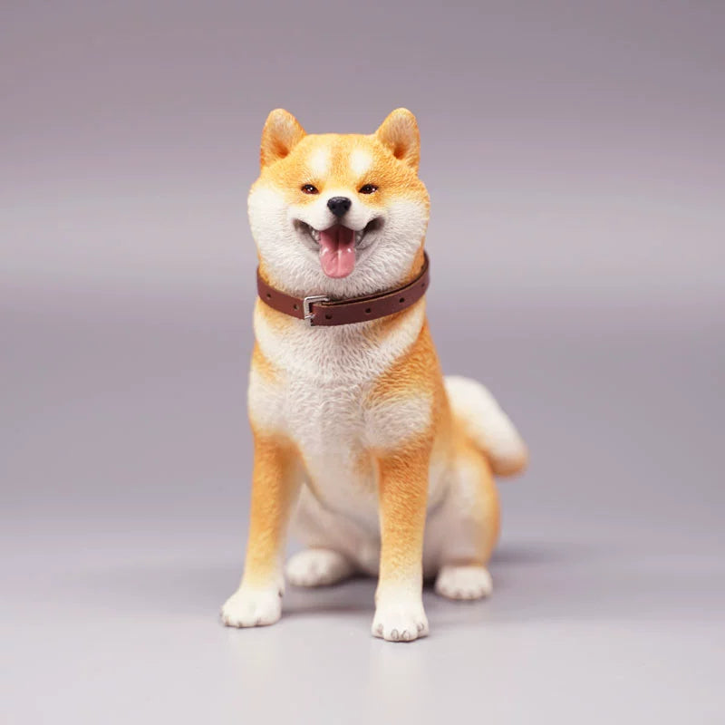 "Three realistic 1/6 scale Shiba Inu dog figurines in a sitting position, showcasing their adorable airplane ear feature. The figurines display three different coat colors: black and tan, red and white, and pure white. Each figurine is intricately detailed with a leather collar, capturing the breed's characteristic cheerful expression."