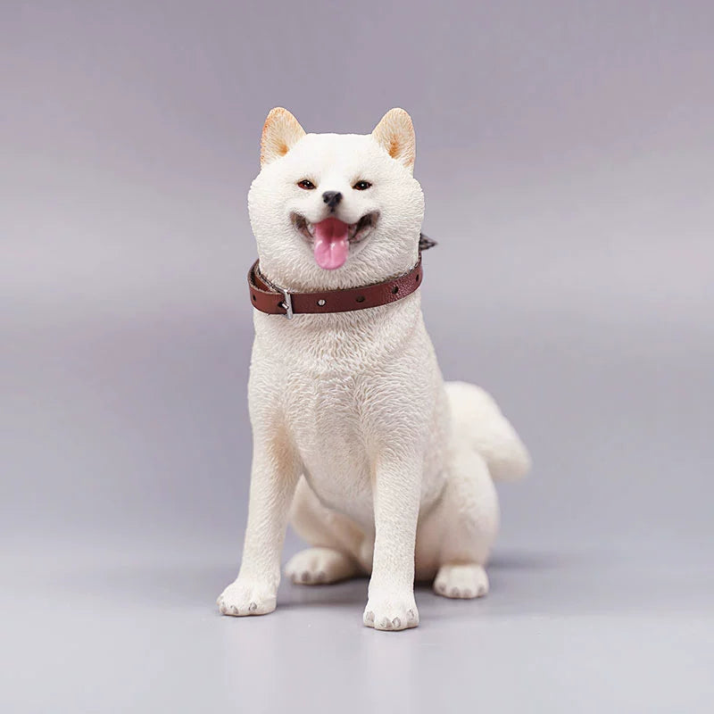 "Three realistic 1/6 scale Shiba Inu dog figurines in a sitting position, showcasing their adorable airplane ear feature. The figurines display three different coat colors: black and tan, red and white, and pure white. Each figurine is intricately detailed with a leather collar, capturing the breed's characteristic cheerful expression."