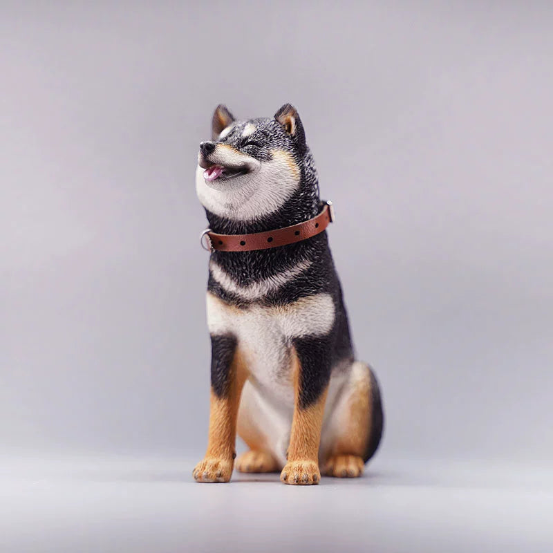 "Three realistic 1/6 scale Shiba Inu dog figurines in a sitting position, showcasing their adorable airplane ear feature. The figurines display three different coat colors: black and tan, red and white, and pure white. Each figurine is intricately detailed with a leather collar, capturing the breed's characteristic cheerful expression."