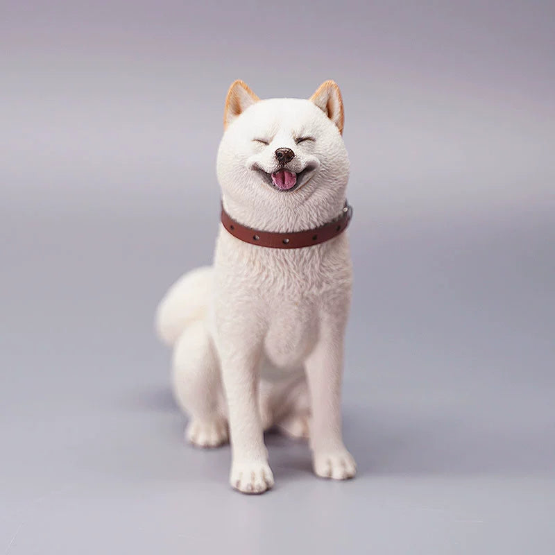"Three realistic 1/6 scale Shiba Inu dog figurines in a sitting position, showcasing their adorable airplane ear feature. The figurines display three different coat colors: black and tan, red and white, and pure white. Each figurine is intricately detailed with a leather collar, capturing the breed's characteristic cheerful expression."