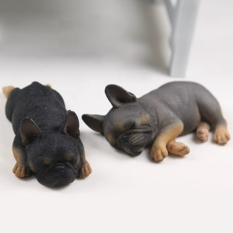 This image features a pair of intricately detailed 1/6 scale French Bulldog models in a sleeping position. The lifelike design captures the essence of these adorable dogs, making them perfect for collectors and dog enthusiasts. Each model showcases a different color variation, adding variety to your collection.