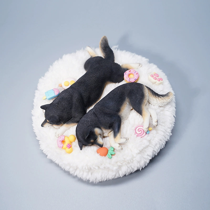 A detailed resin model of a sleeping Shiba Inu dog on a fluffy white bed, surrounded by colorful toy replicas like a carrot, ice cream cone, donut, and paw print. The model captures the serene essence of a Shiba Inu with its realistic fur texture and lifelike posture, ideal for collectors and dog enthusiasts.